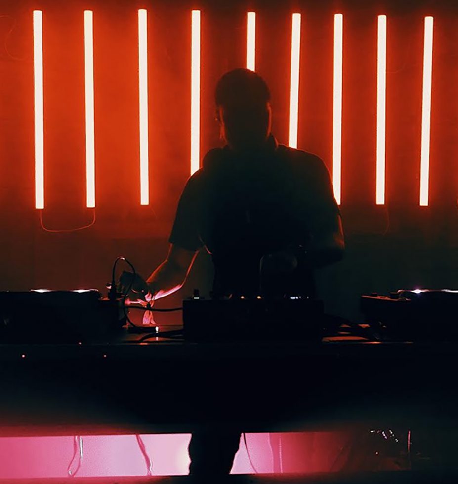 Dj mixing song with the red light behind