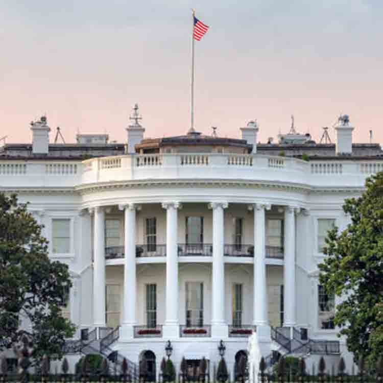 White house with American flag hoists on the roof