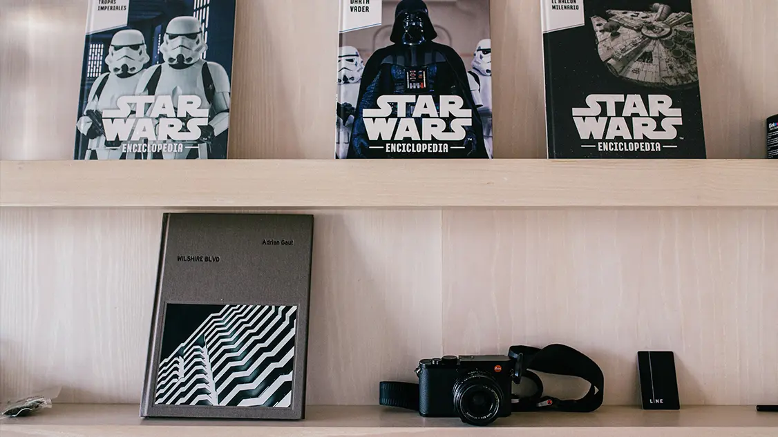 Collection of Star wars books and camera on the racks