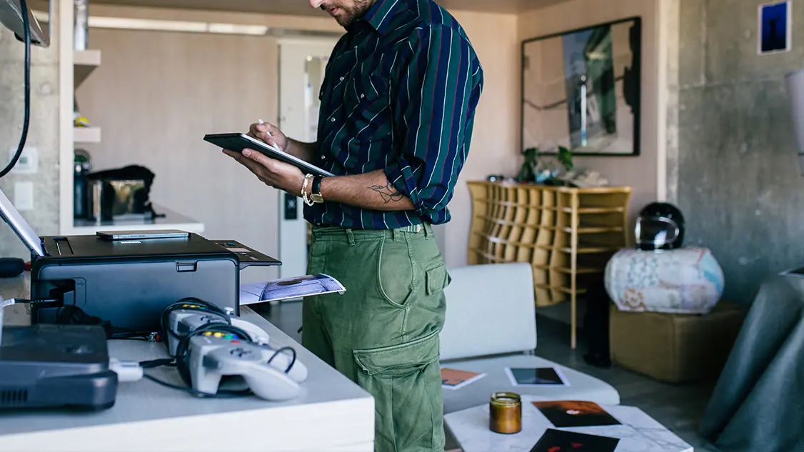Man looking on the tablet and examining something