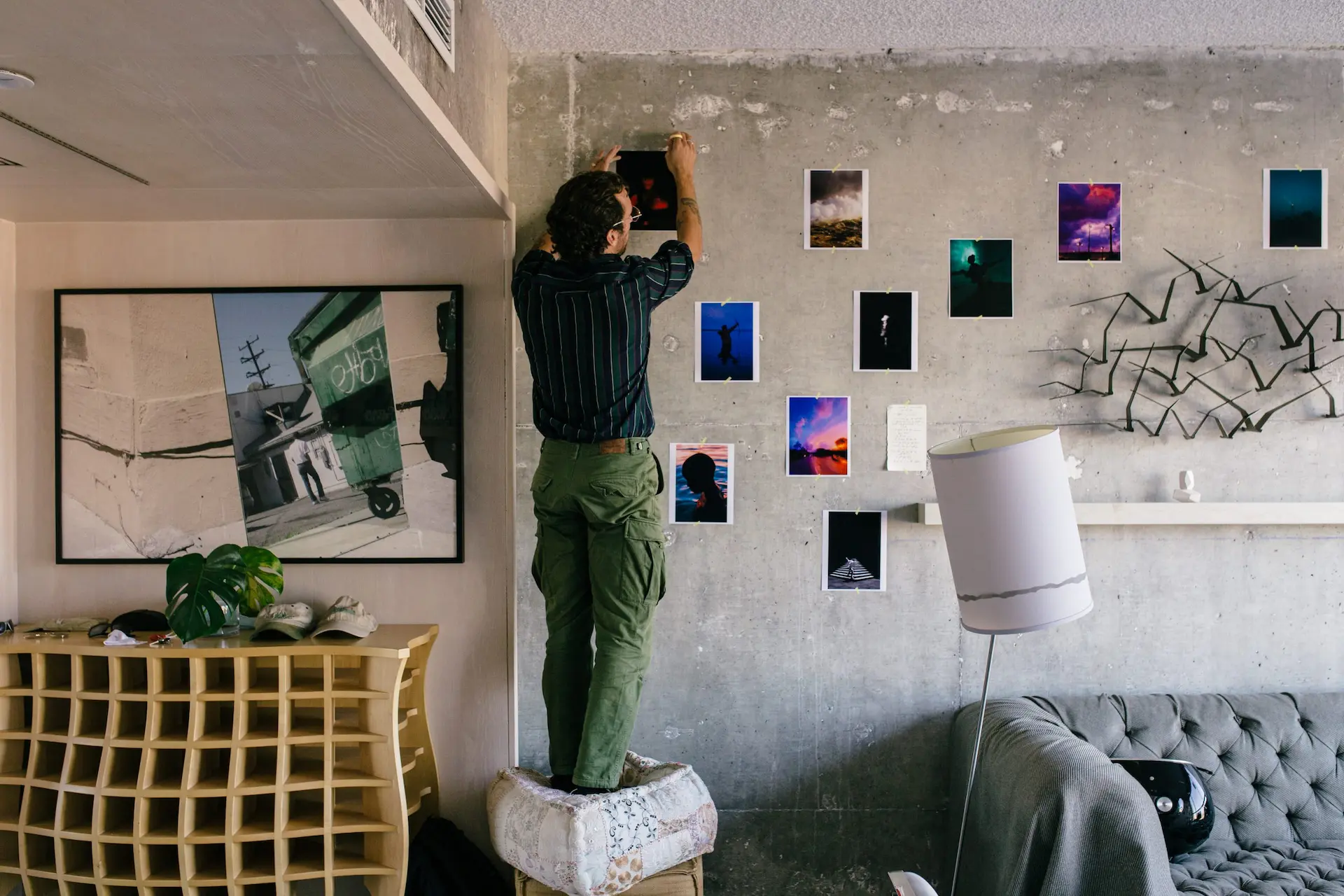 Man trying to hang the painting on the wall