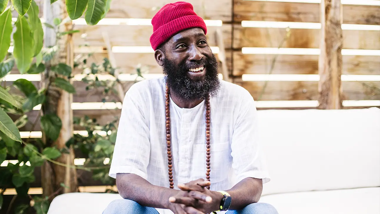 Happy man sitting on couch smiling