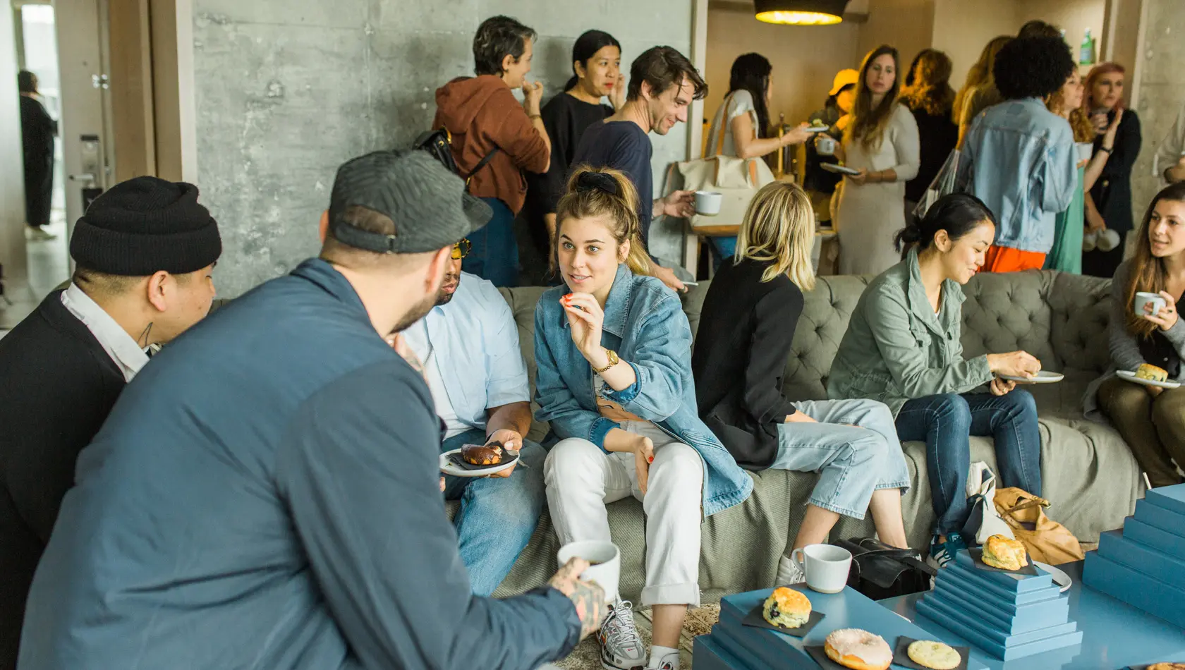 Many people discussing and eating in a event