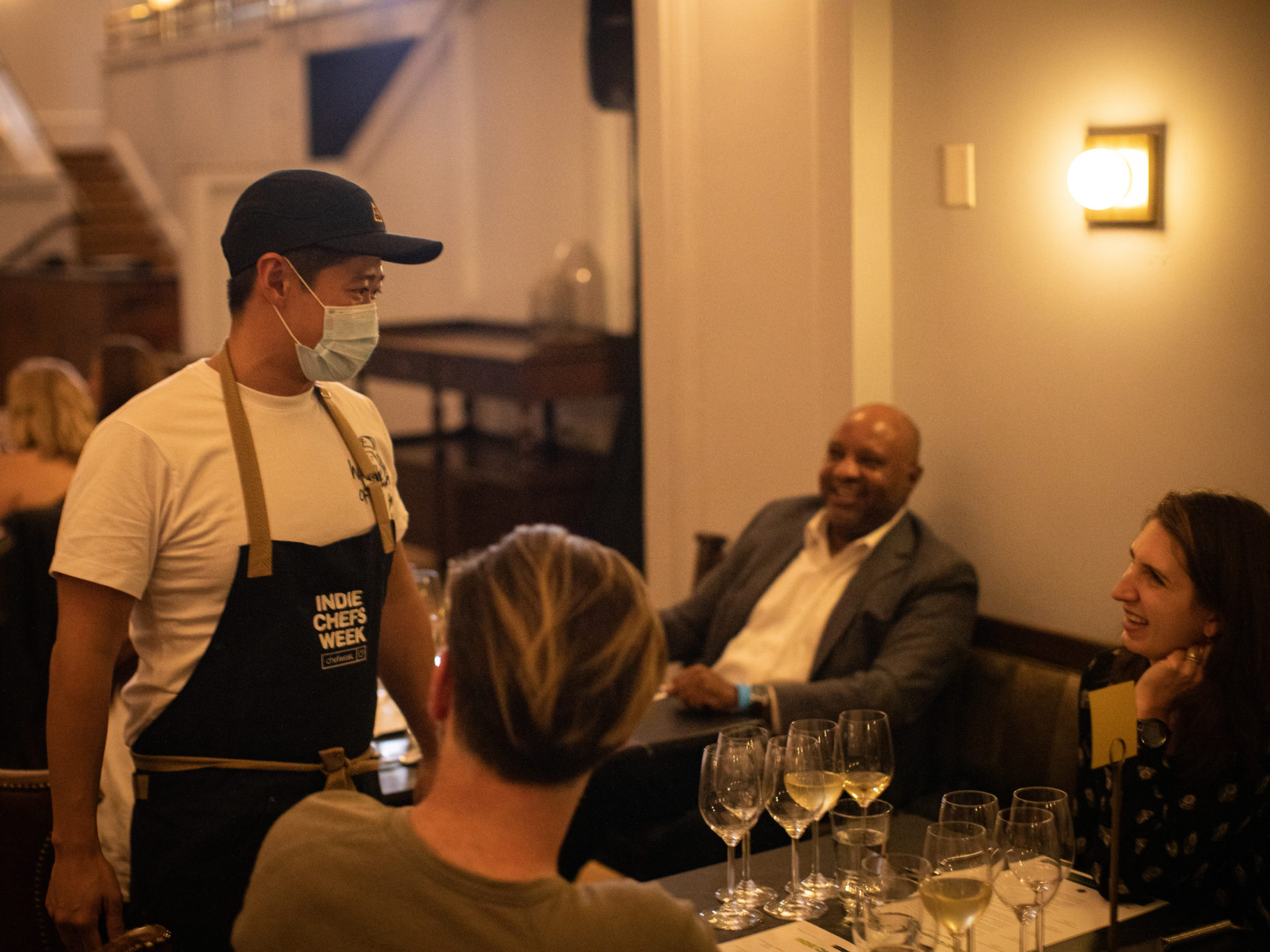 People talking to waiter and laughing