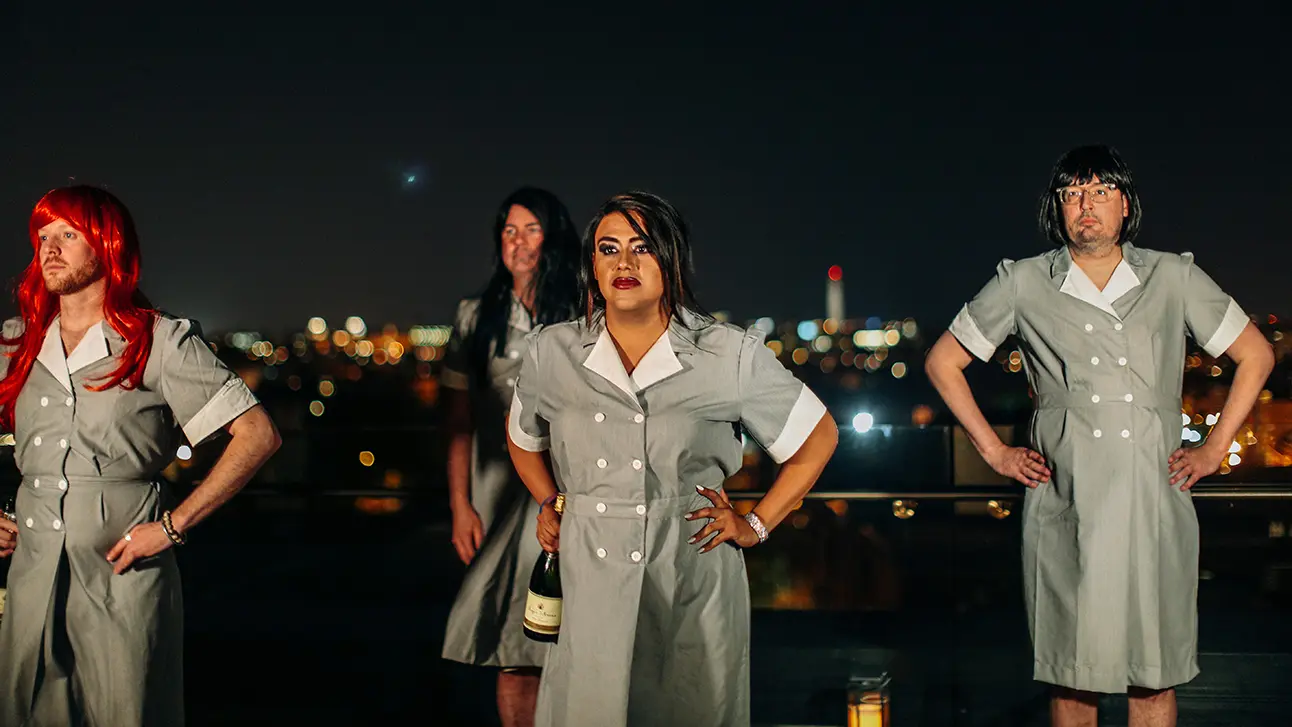 People dressed like a girl standing in the top of the building