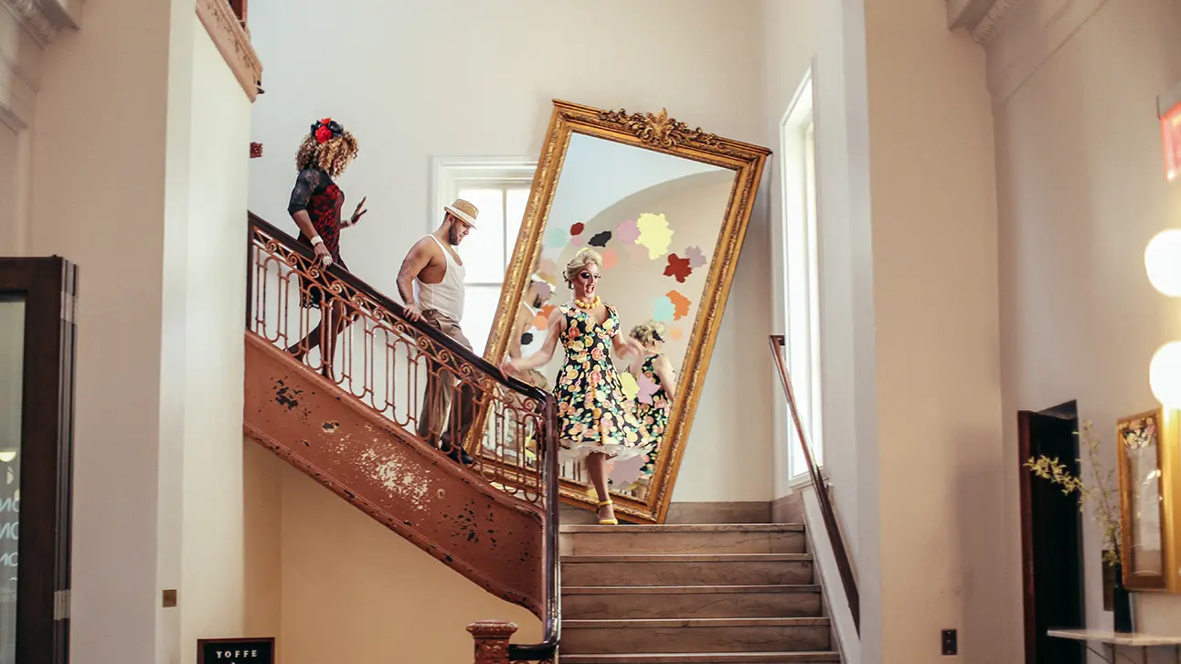 People coming downstairs with a painting