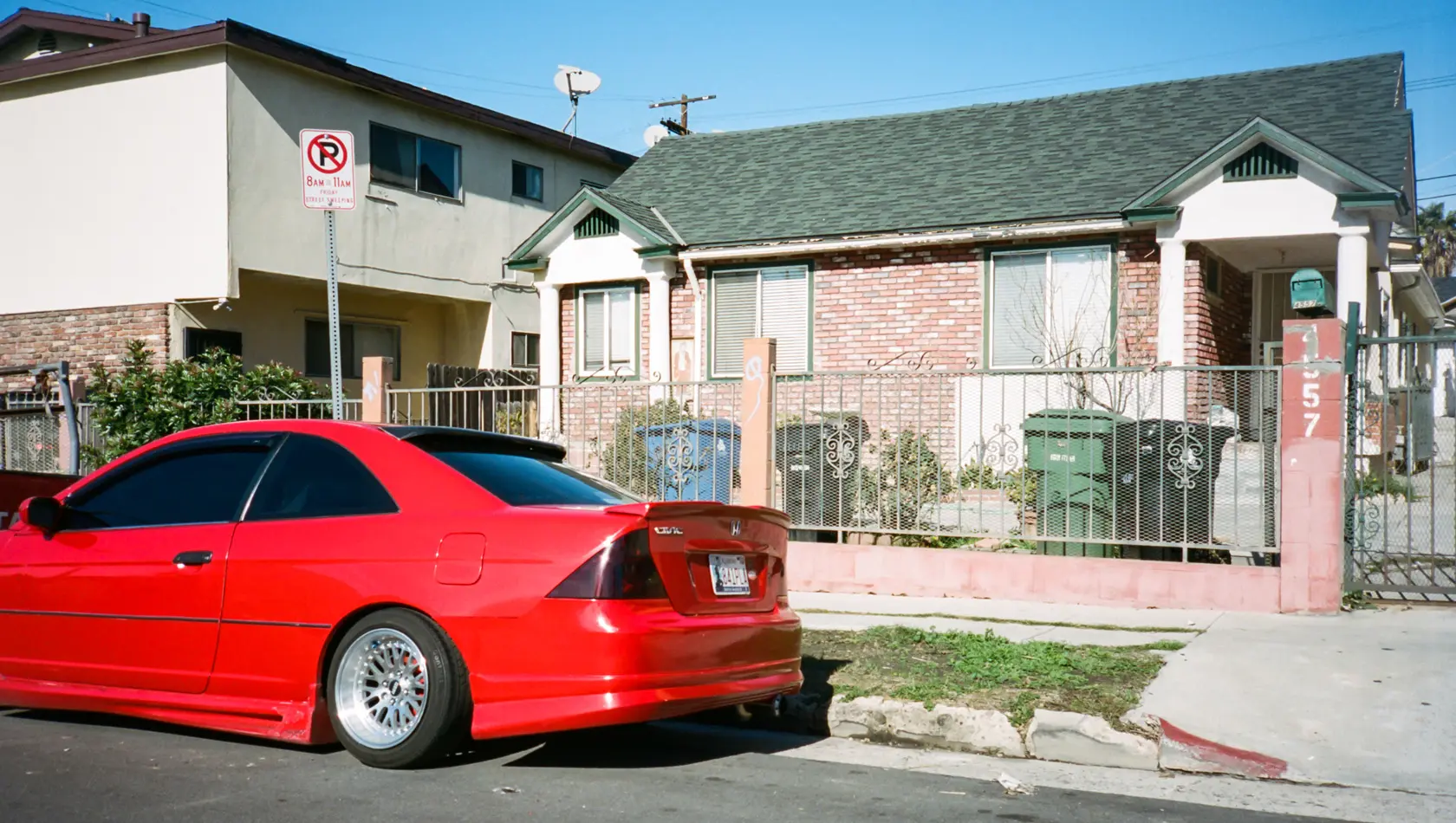 Modified red Honda Civic Coupe 2003 parked in front of the house