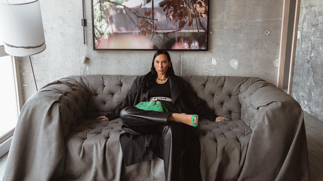 Girl sitting on a sofa with grey background