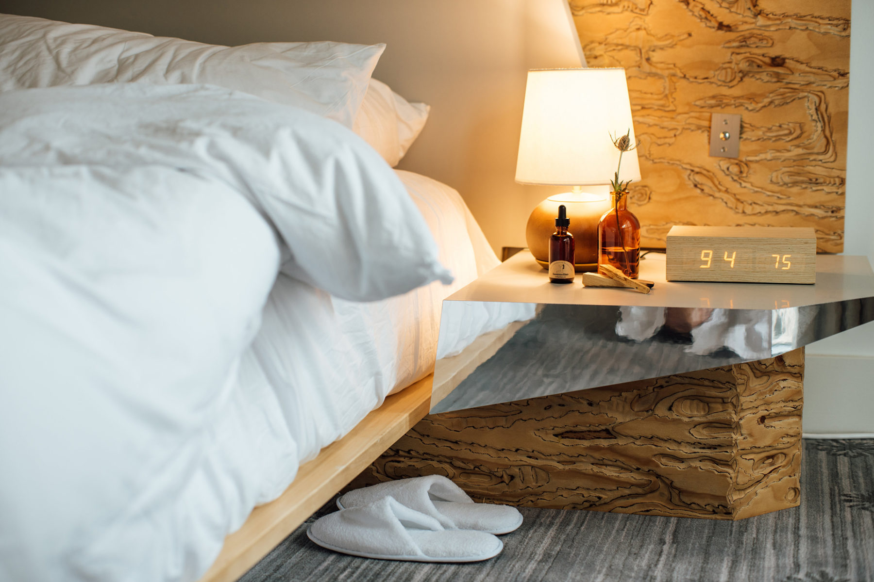 A pristine white bed with a cozy white bathroom slipper tucked underneath for added comfort and relaxation