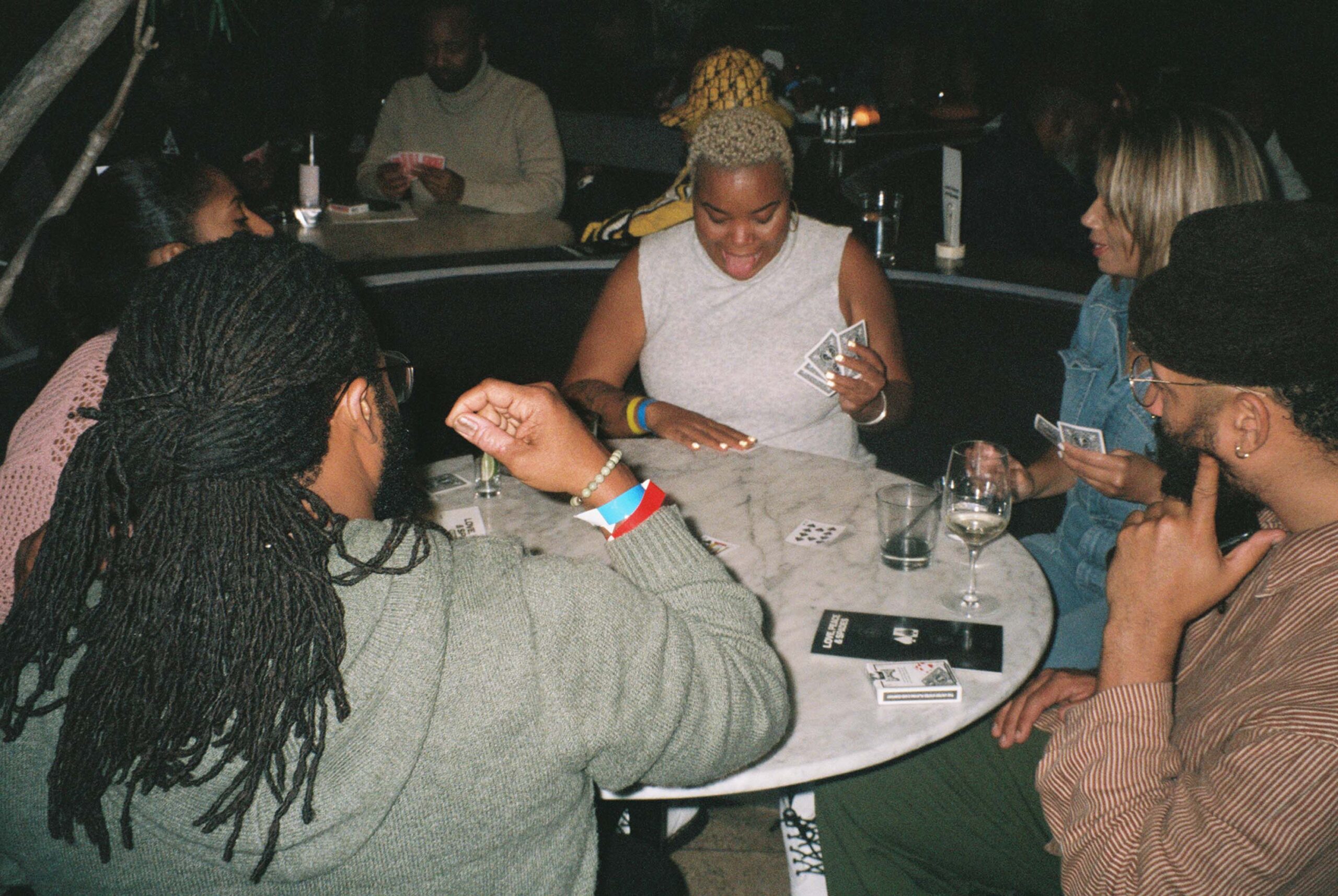 People sit around a table having fun playing card games