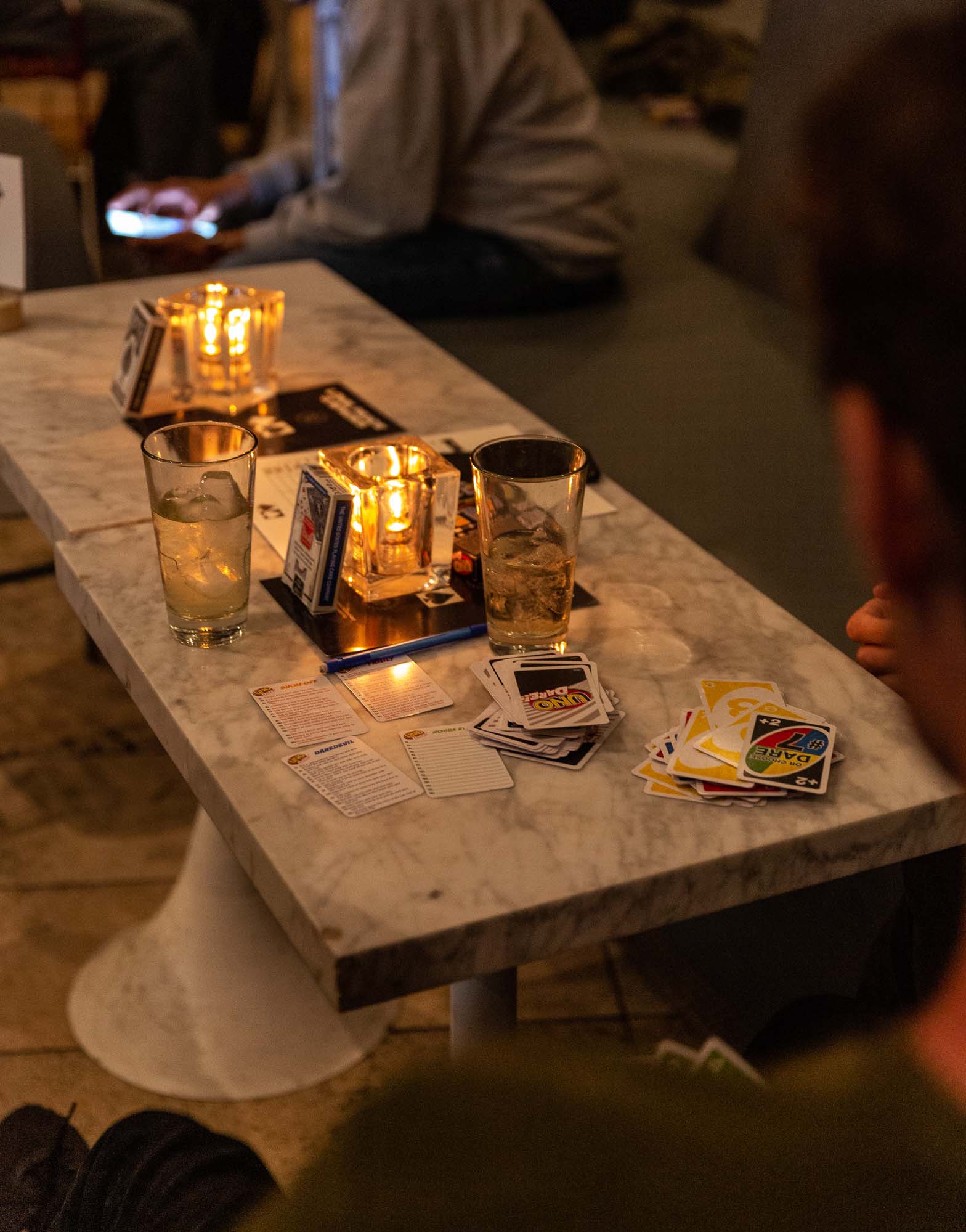 Marble table adorned with neatly arranged cards and water glasses in a picturesque setup.