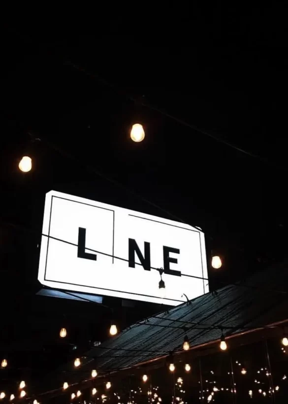 Line logo glowing light on a building