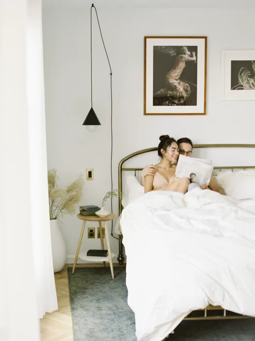 Couple relaxing in bed at the LINE Hotels – romantic city escape.