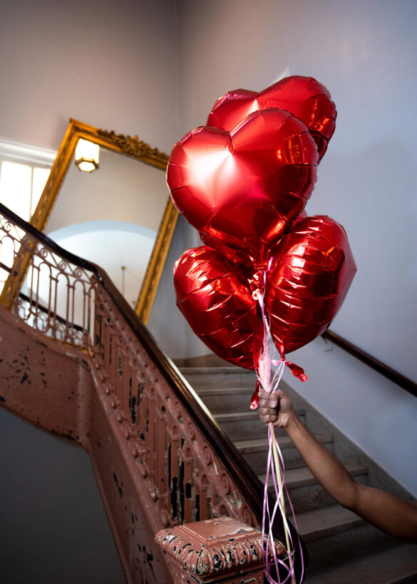 Red heart balloons on a staircase