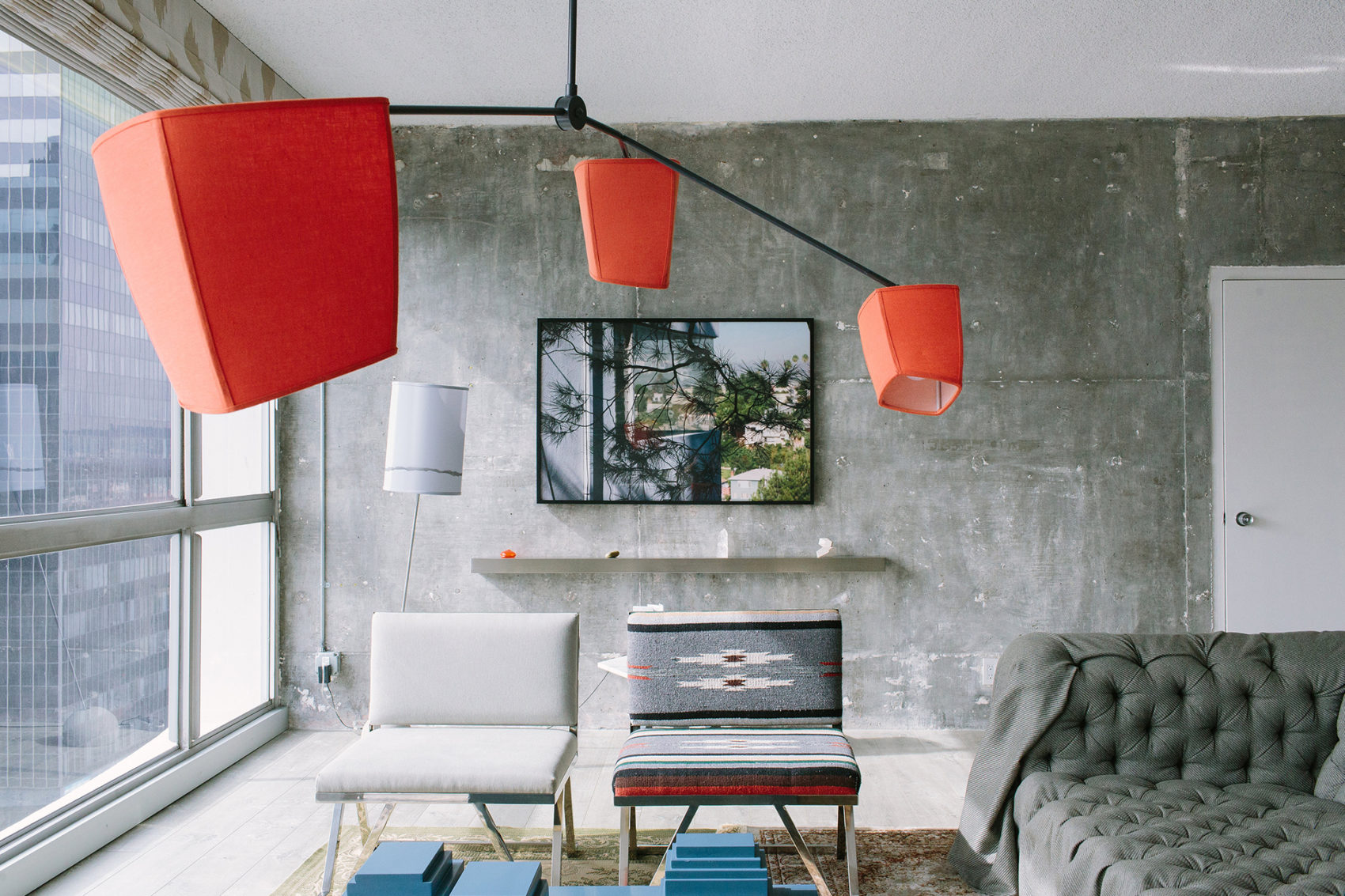 Red hanging lamp with sofa set and transparent glass window