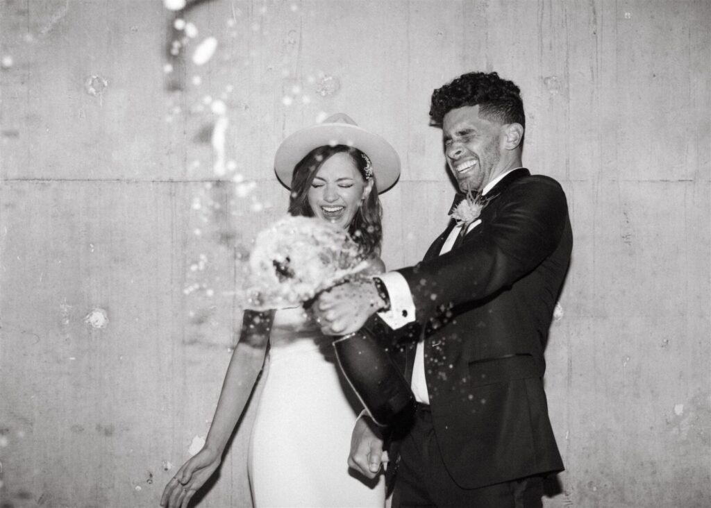 Black and white photo of a couple opening camphane bottle