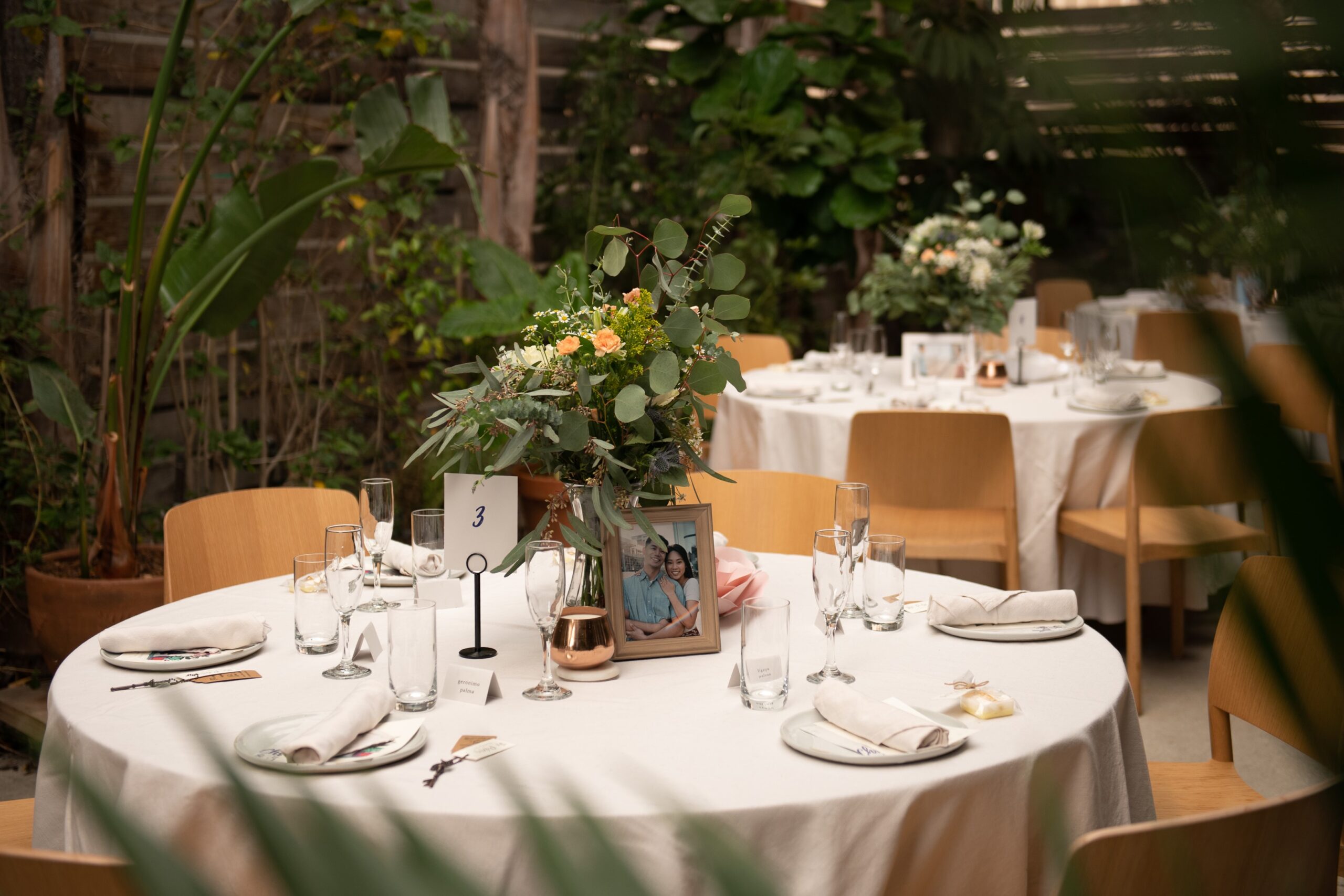 Dining table with glass and plate is set openaire wedding