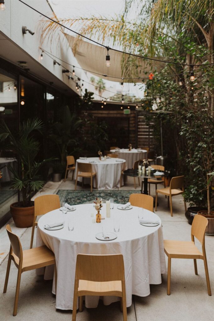 Dining table with glass and plate is set openaire wedding