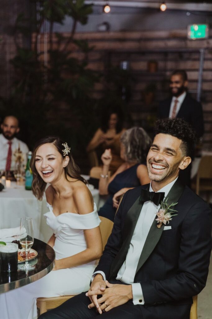 Married couple sitting and laughing 1