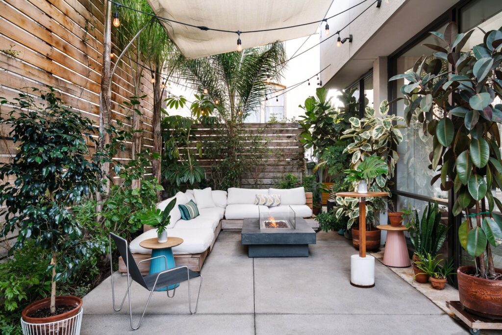 Portico with sofa and table having a lot of plants