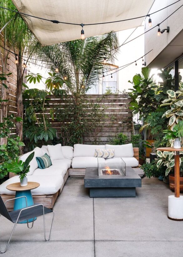 Portico with sofa and table having a lot of plants