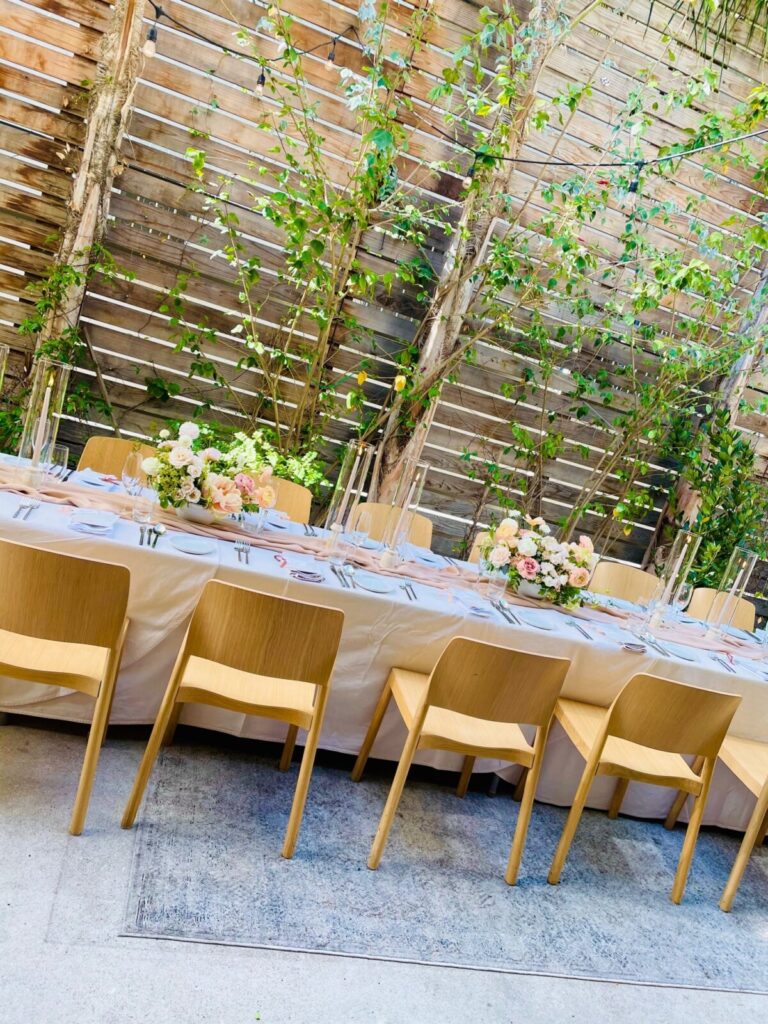 Dining table with glass and plate is set openaire wedding
