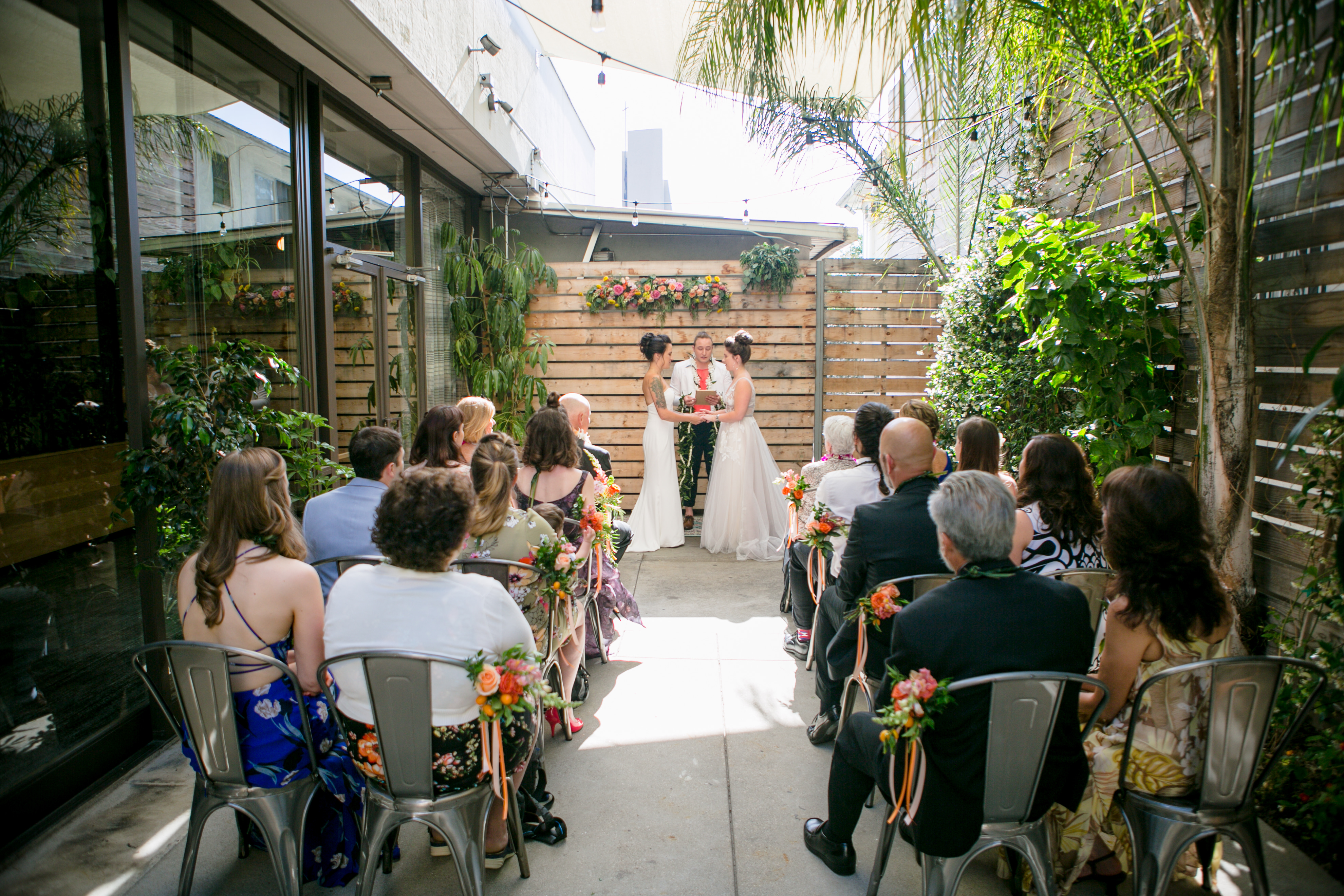 a wedding ceremony taking place in an outdoor garden