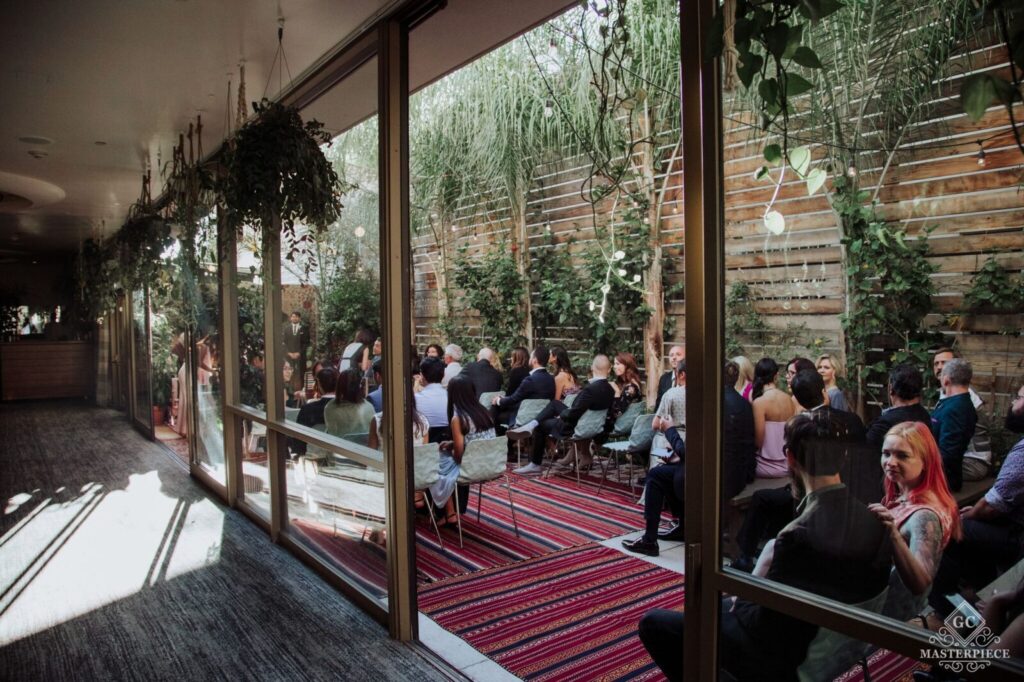 Transparent Glass window with the crowd standing outsdioiside