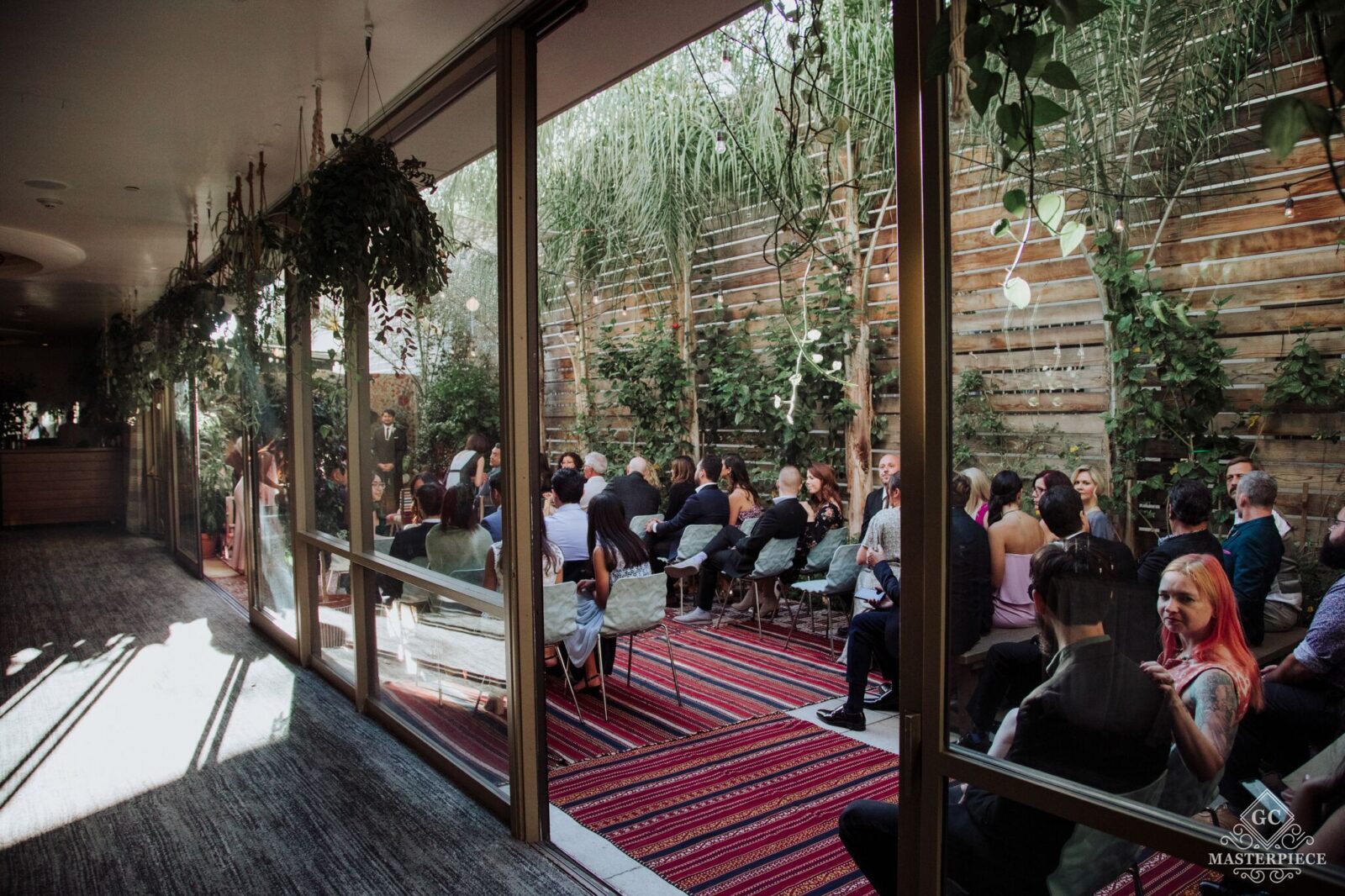 Transparent Glass window with the crowd standing outsdioiside