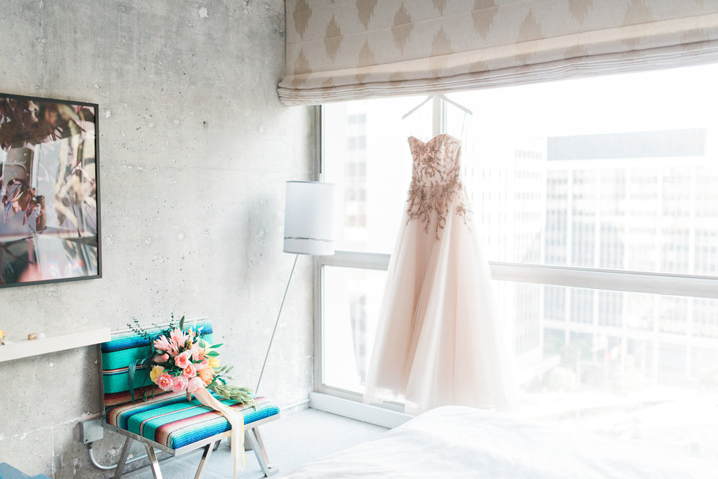 Bride dress hanging on the transparent glass window