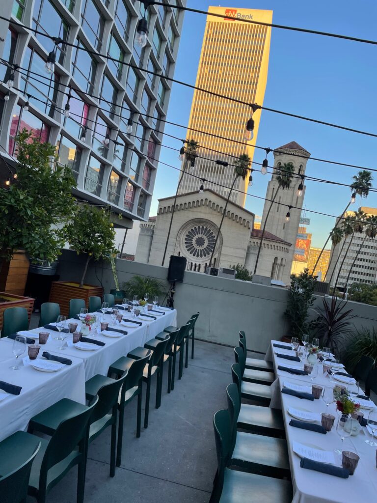 Dining table with glass and plate is set openaire wedding