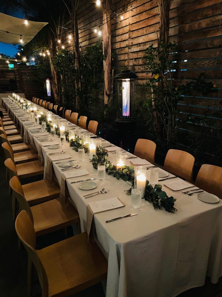 Dining table with glass and plate is set openaire wedding
