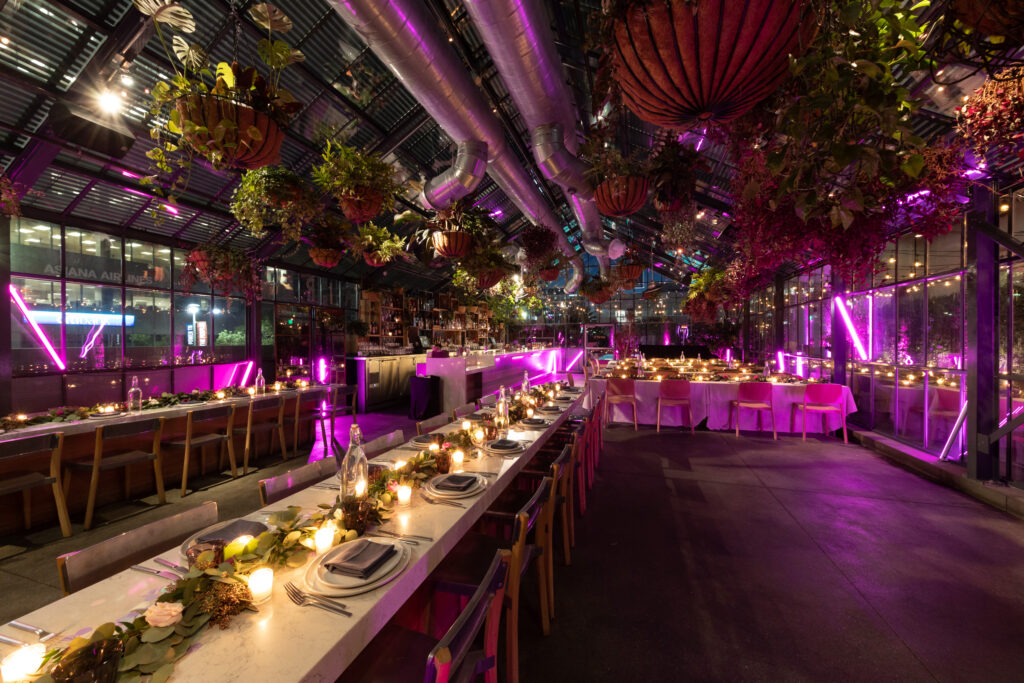 Dining table in night with glass and plate is set openaire wedding