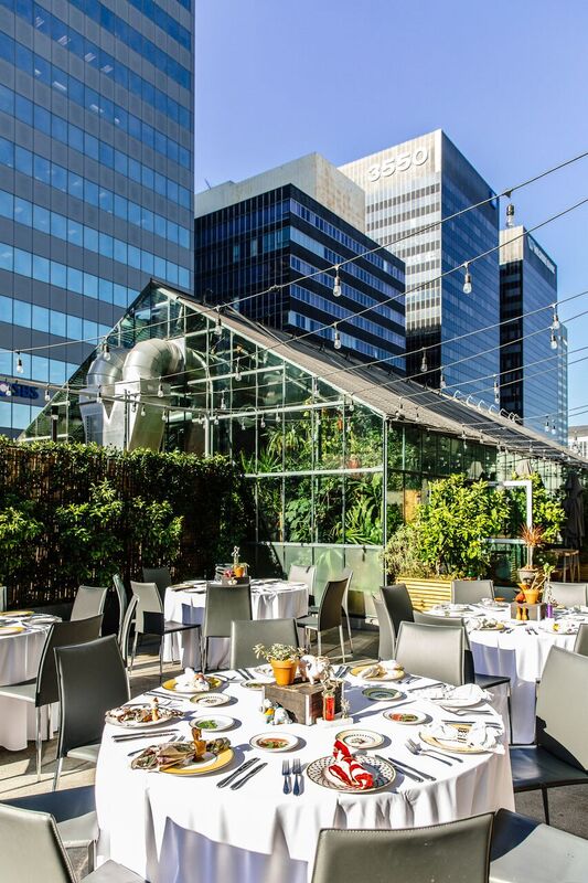 Dining table with glass and plate is set openaire wedding