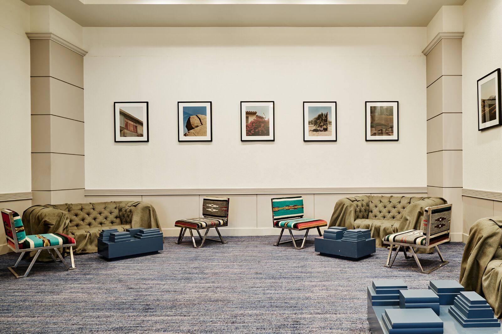 Two sofa and four chairs with multiple paintings