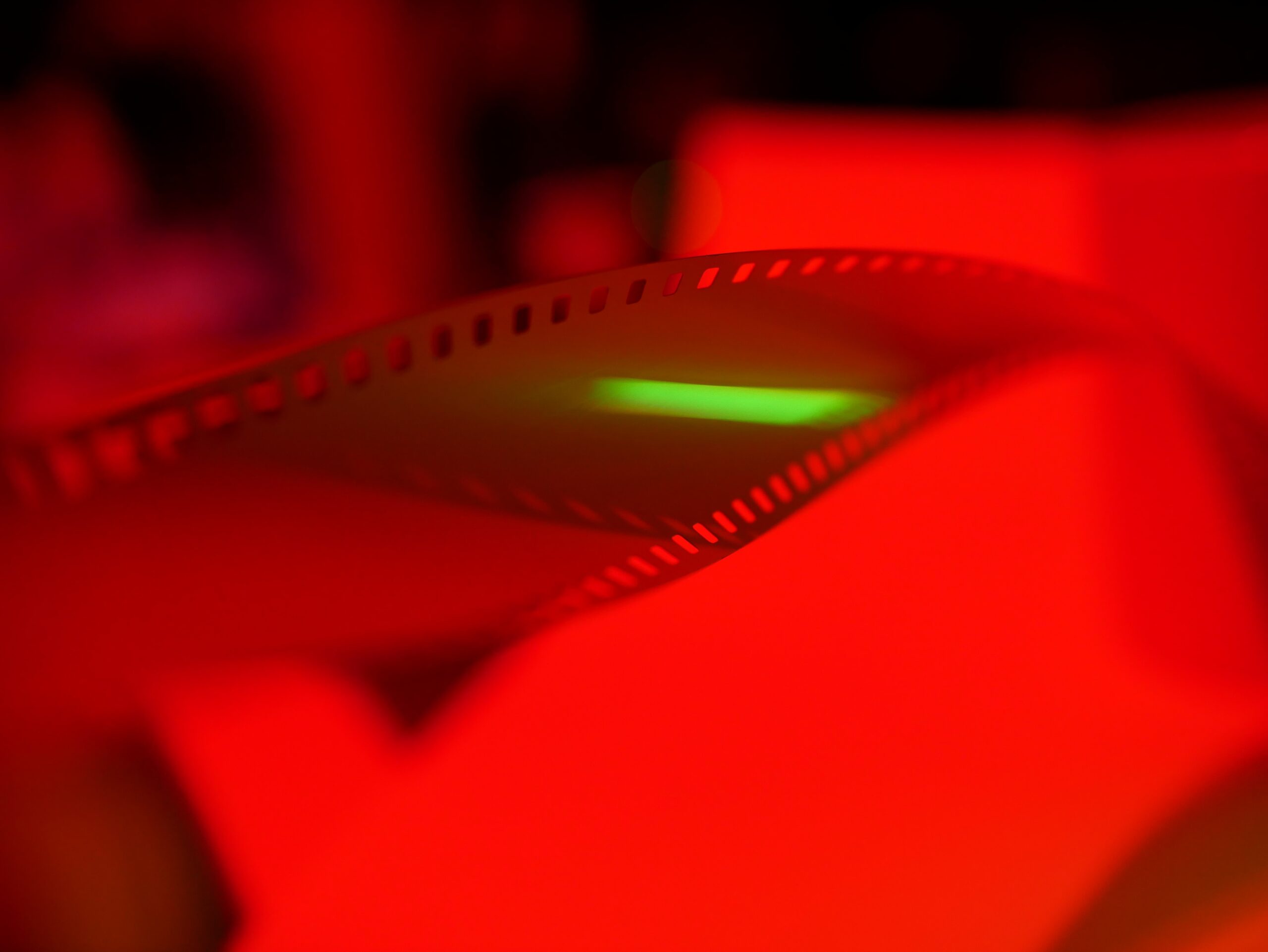 Film on a light table in a red, photo-developing dark room