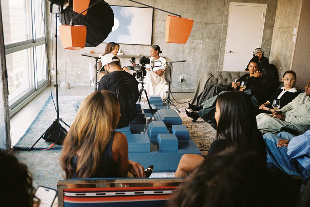 a group of people sitting around in discussion