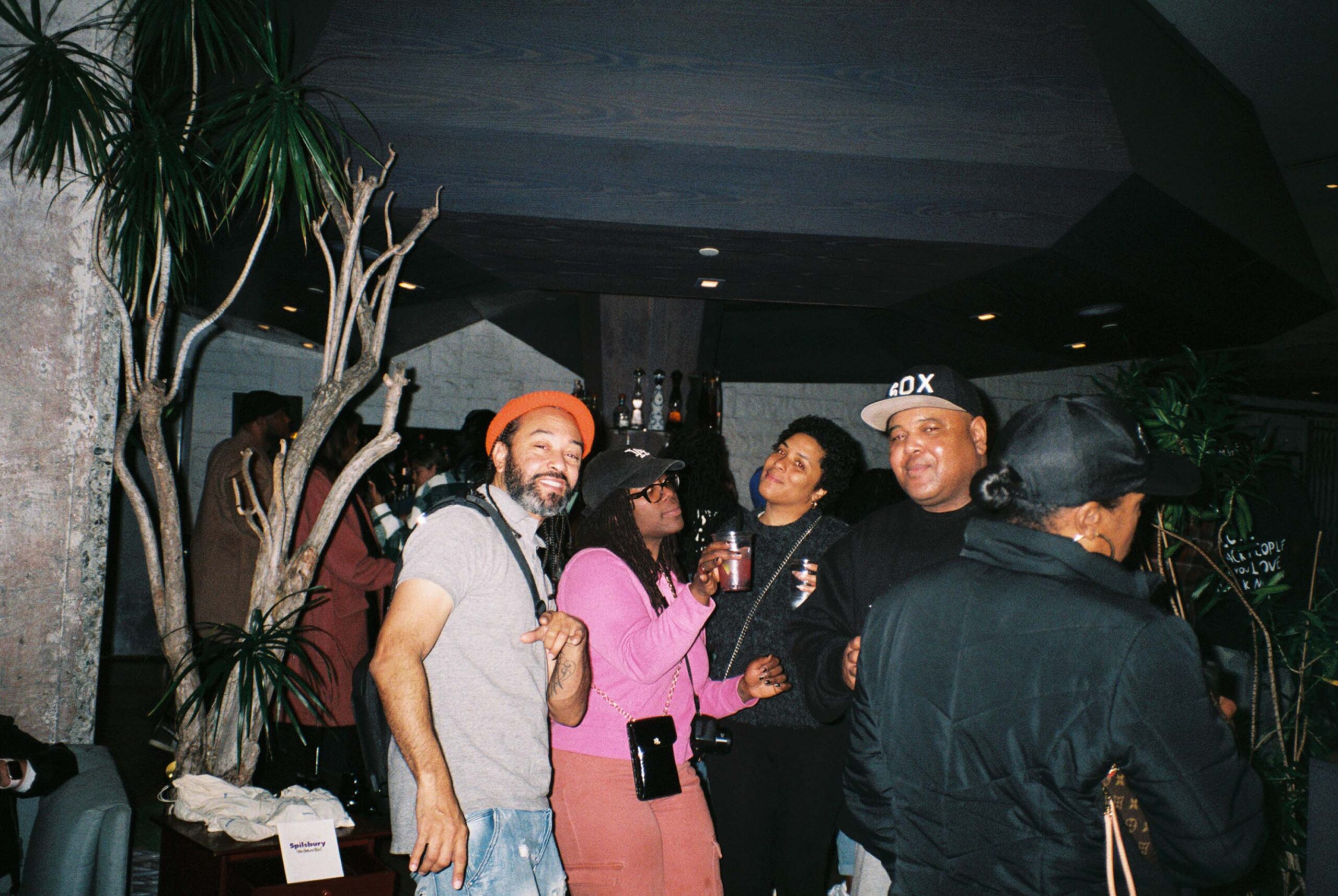 Friends enjoying drinks together at a bar during a night out.