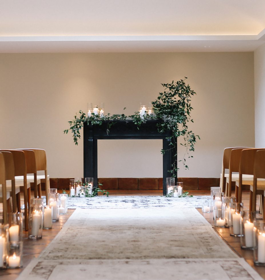 Candle light white room with brown tables and plants