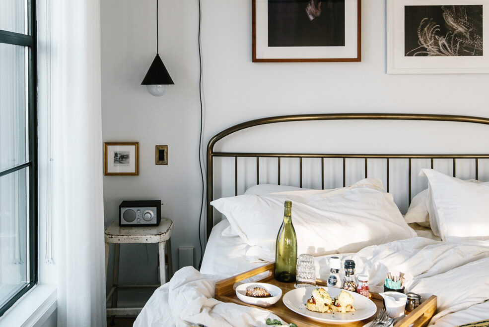 Picture of bed with dishes with food