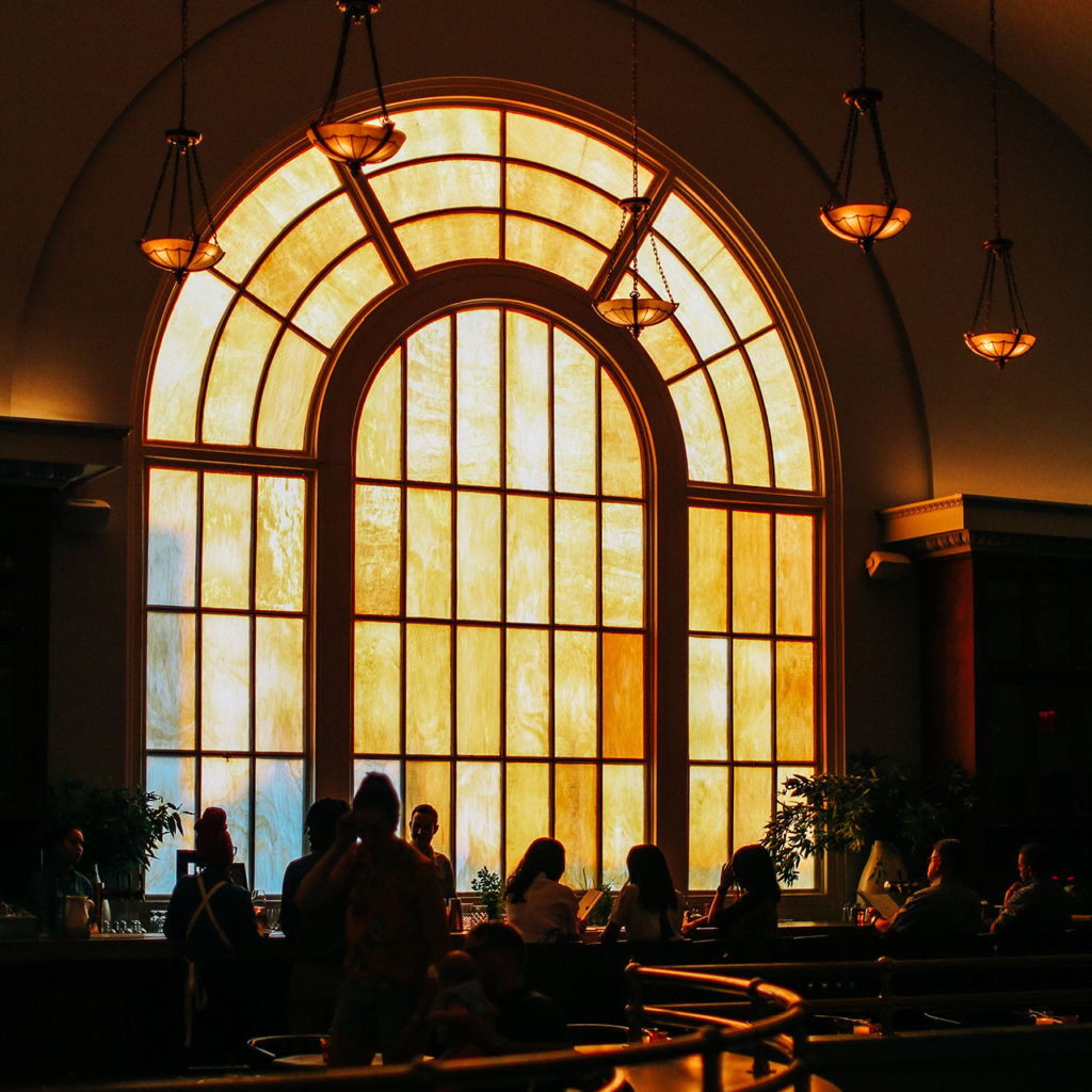 Picture of hall with hanging lights and window with sunlight