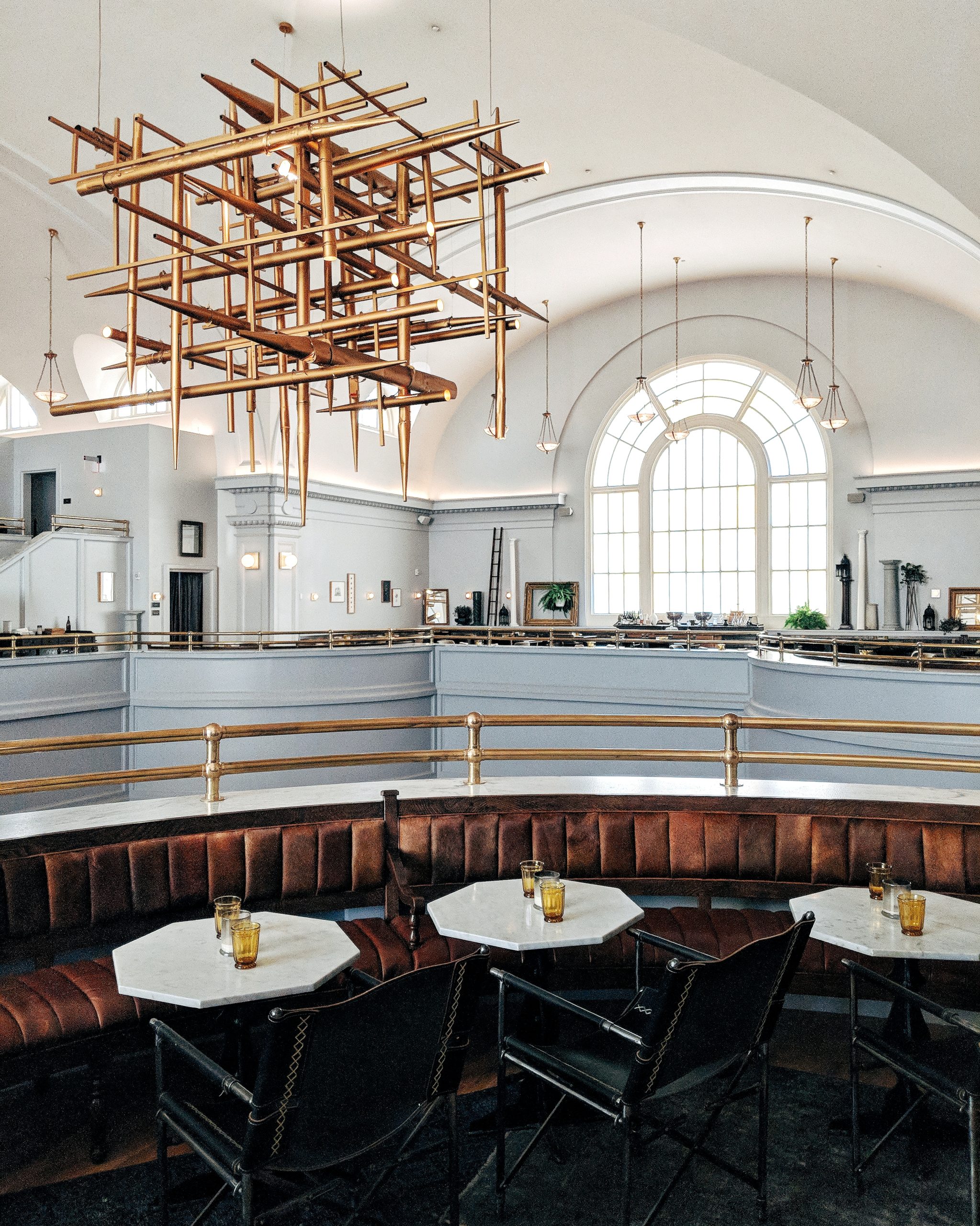 Picture of a halls balcony with big sofa and chair and a metal hanging