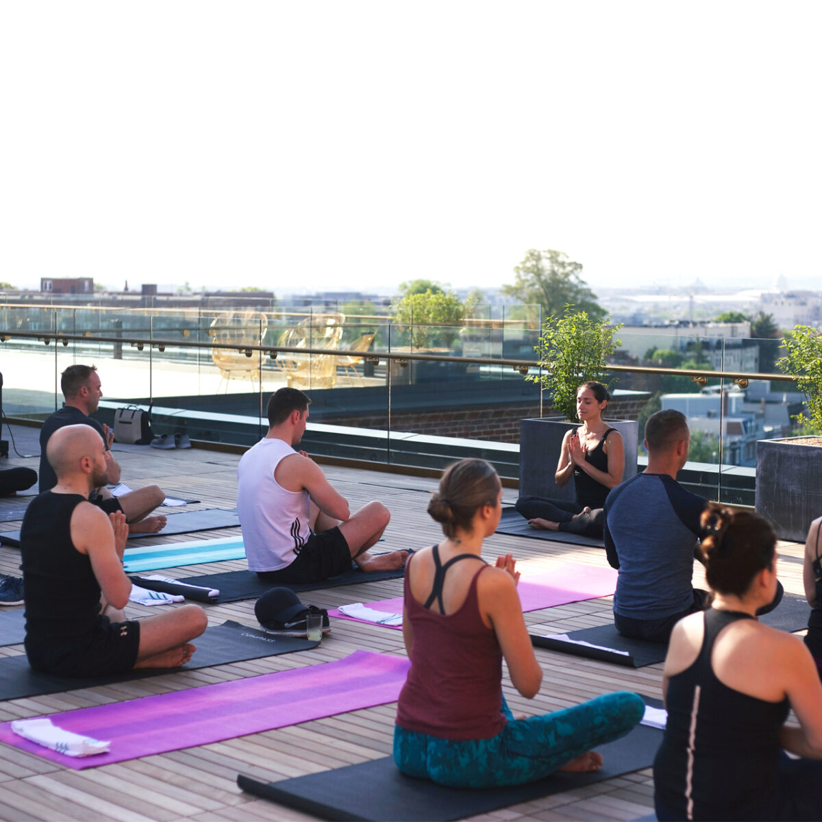 A group of people doing yoga on the rooftop