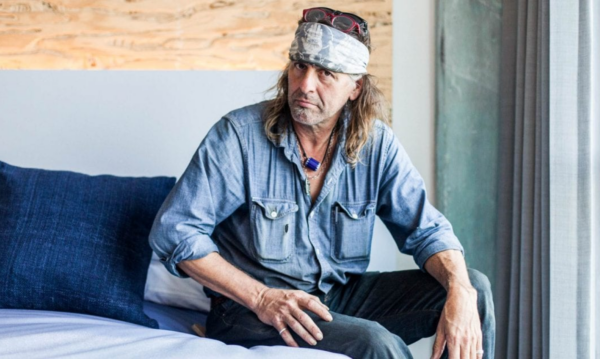 Picture of Evan Voyles sitting on a bed