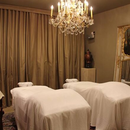 The picture of tables covers with white bedsheets with background of brown curtains