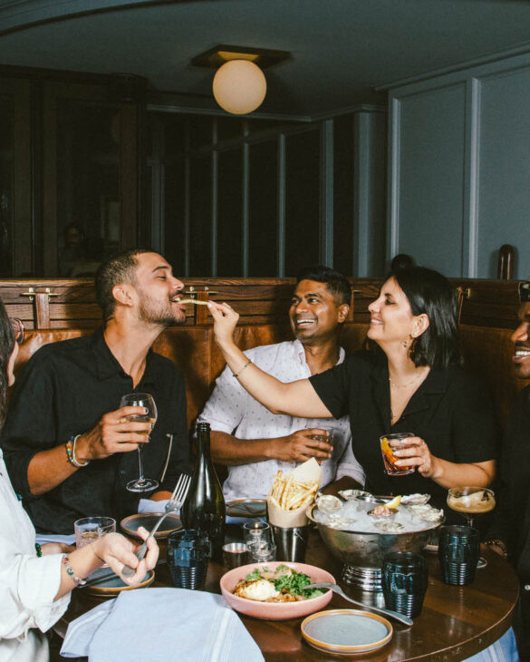 a group of people around table full of food and drink