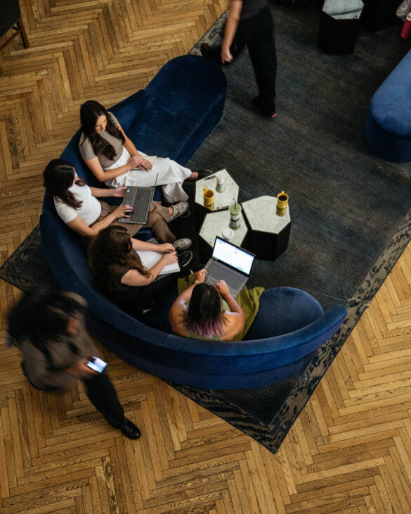 a group of people sitting with their phones and laptops