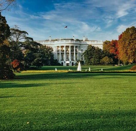 The White House with its lawn and fountains in Washington, DC., on a sunny day