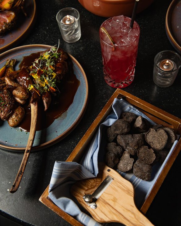 roasted veal chop, served alongside crispy fingerling potatoes and thyme jus and black truffles