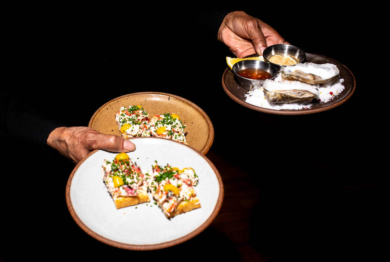 food on plates with black background